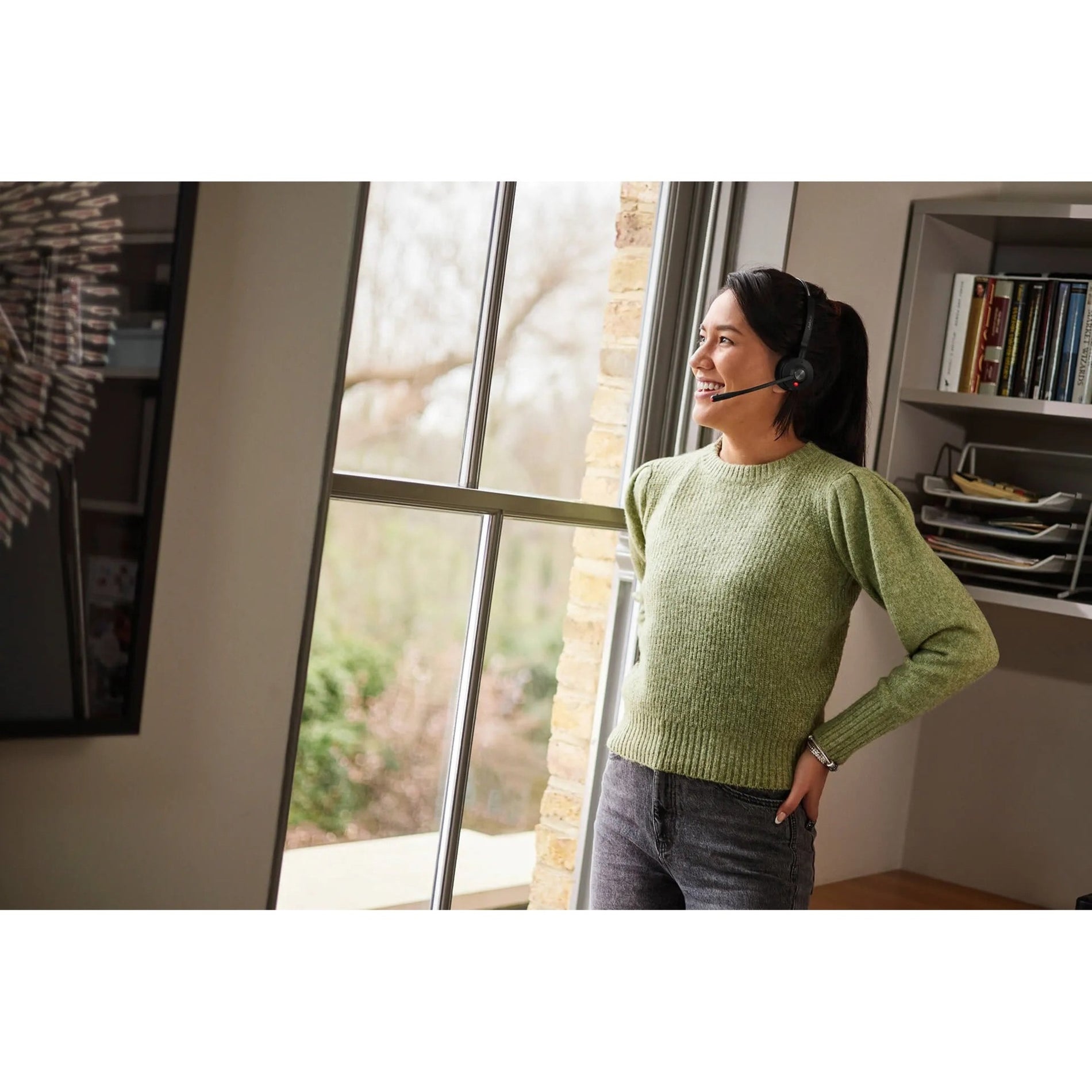 Person standing by window wearing Jabra Engage 55 headset during call-alternate-image5