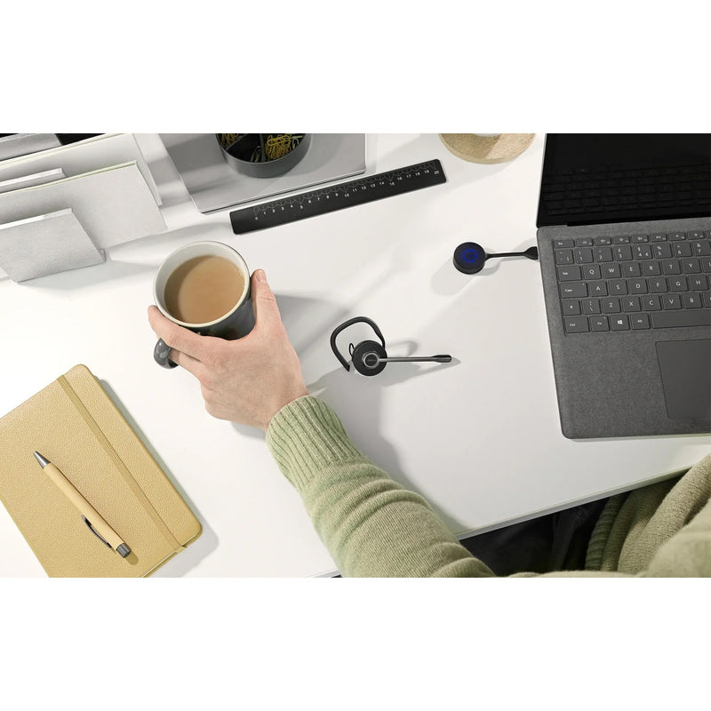 Workspace setup showing Jabra Engage 55 headset in use with laptop and office accessories