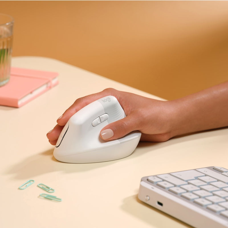 Close-up of hand gripping Logitech Lift vertical mouse showing ergonomic positioning