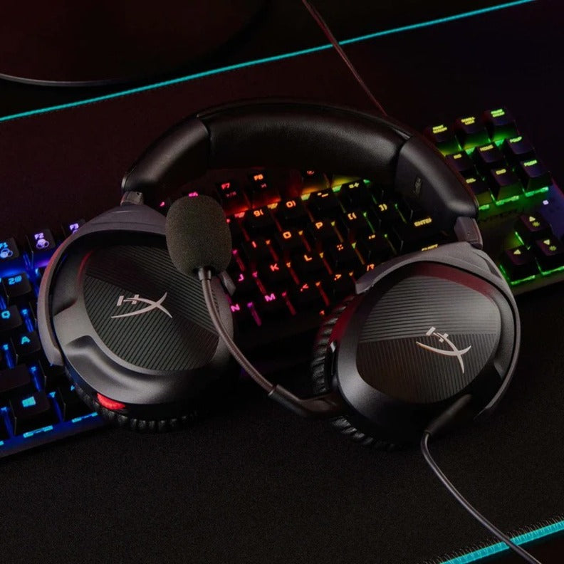 HyperX Cloud Stinger 2 headset displayed with RGB gaming keyboard