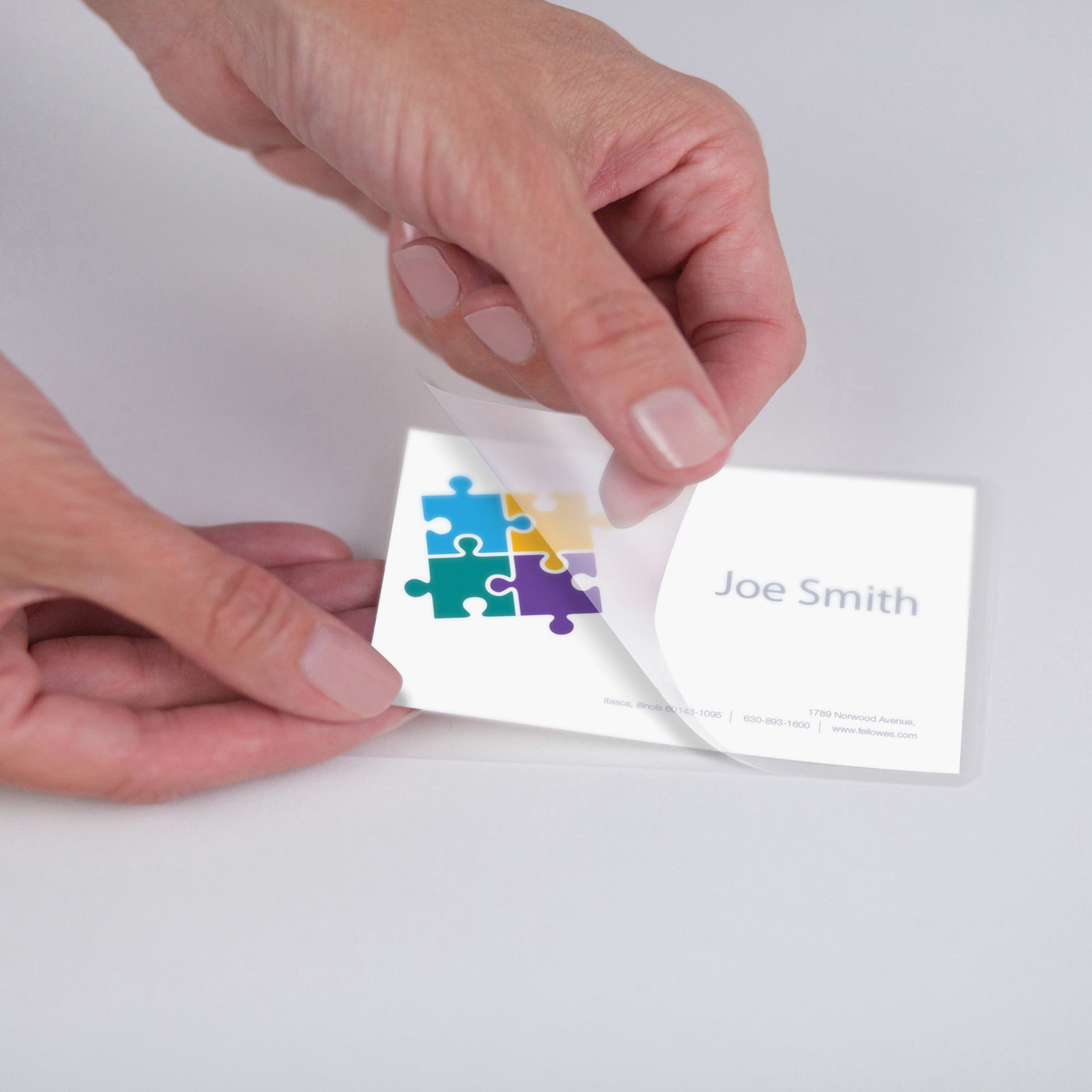 Hands demonstrating easy lamination process with business card-alternate-image7