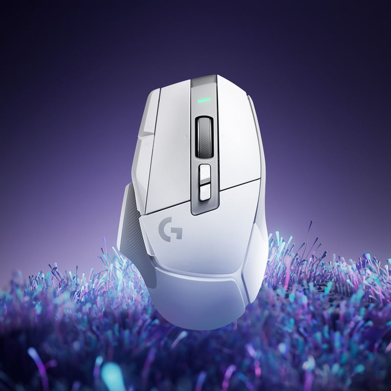 White Logitech G502 X gaming mouse with RGB lighting against purple crystal background