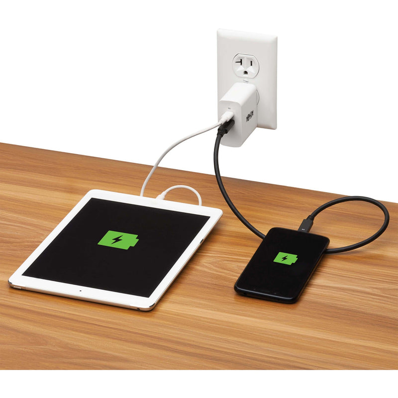 Tripp Lite charger powering both a tablet and smartphone showing charging indicators