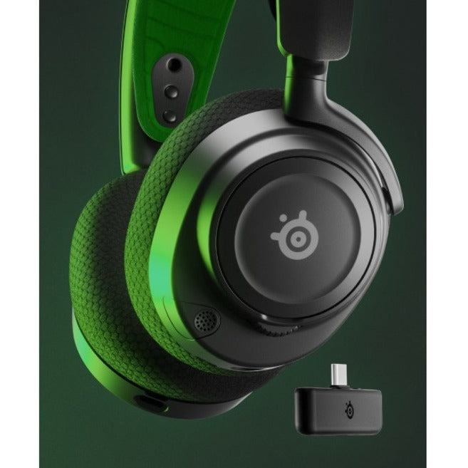 Artistic shot of Arctis Nova 7X with USB-C dongle against green background-alternate-image7