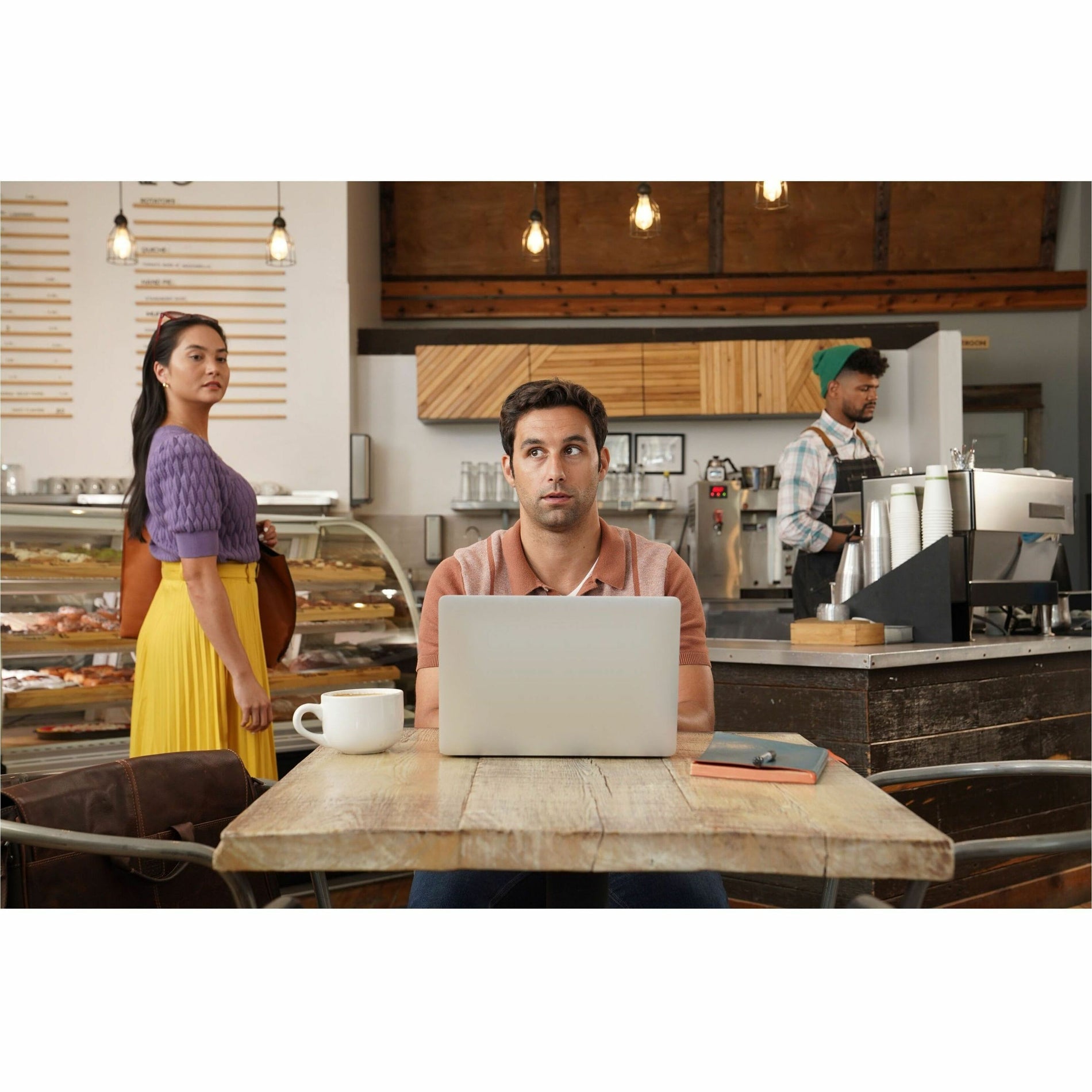 Demonstration of privacy screen effectiveness in cafe setting with onlookers-alternate-image4