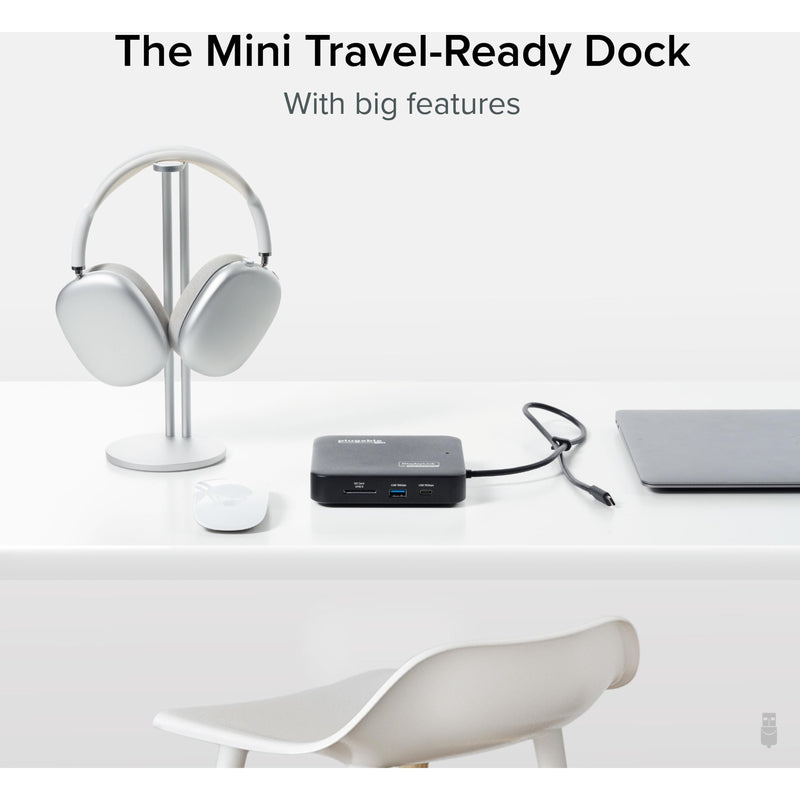 Lifestyle image showing the compact size of the docking station alongside travel accessories