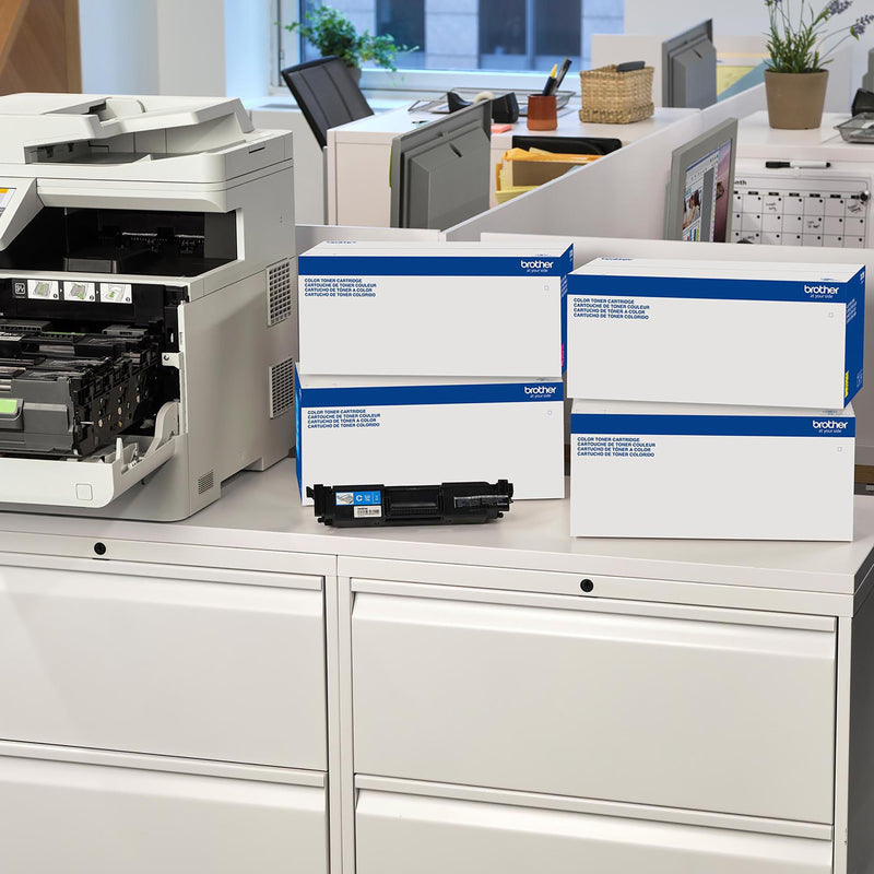 Office setting showing Brother printer and toner cartridges in storage