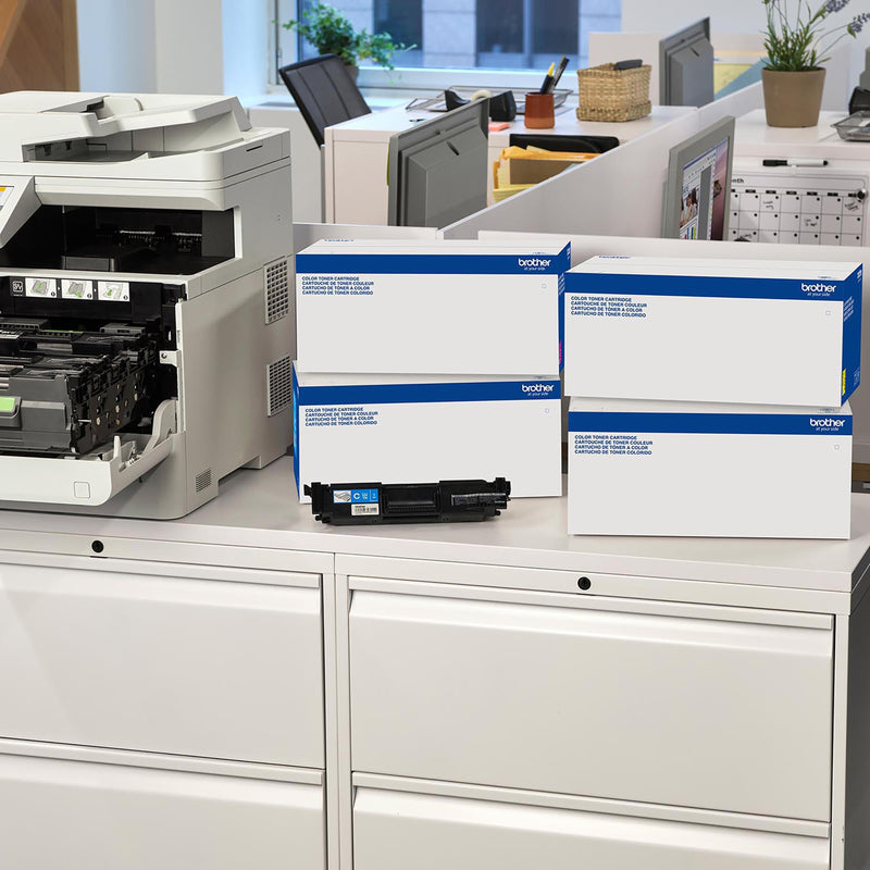 Office setting showing Brother printer and toner cartridges in workplace environment