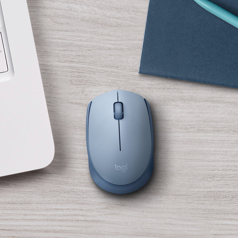 Logitech M170 mouse on desk with laptop and office accessories showing real-world usage