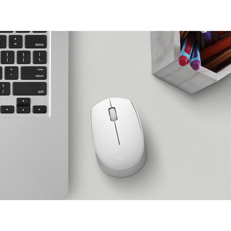 Logitech M170 wireless mouse shown in a modern workspace setting next to a laptop keyboard