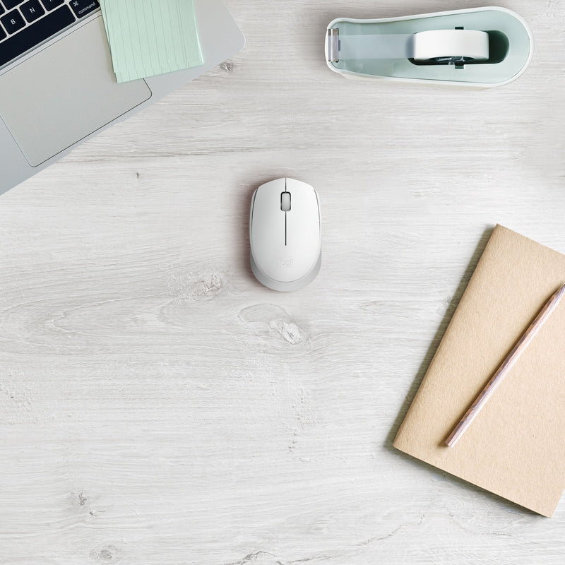 Overhead view of Logitech M170 wireless mouse on a clean white desk with minimal accessories