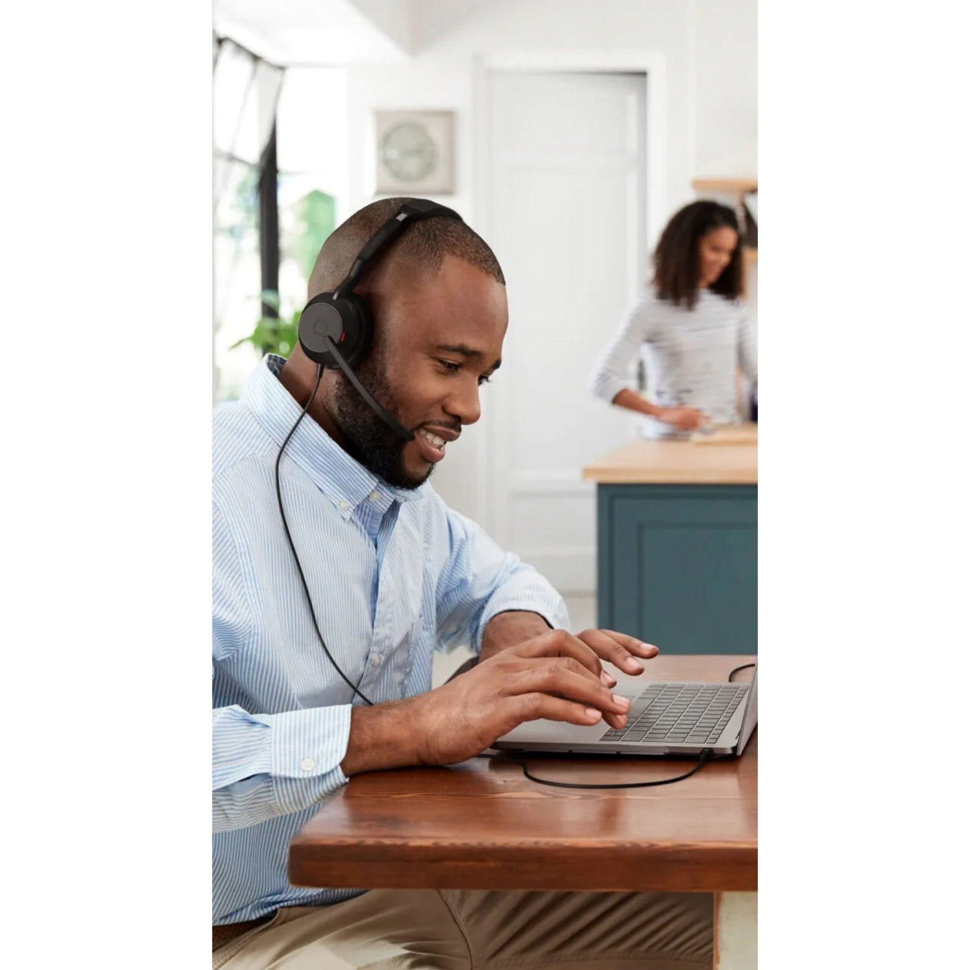 Professional working in shared office space wearing Jabra Evolve2 50 headset-alternate-image6