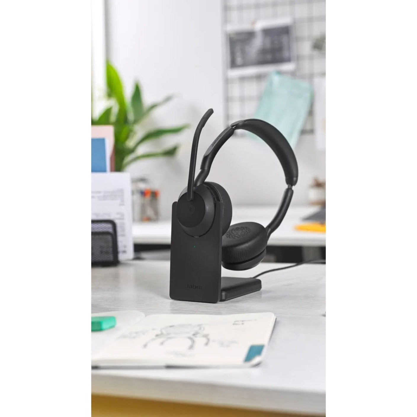 Jabra Evolve2 55 on charging stand in office environment-alternate-image8