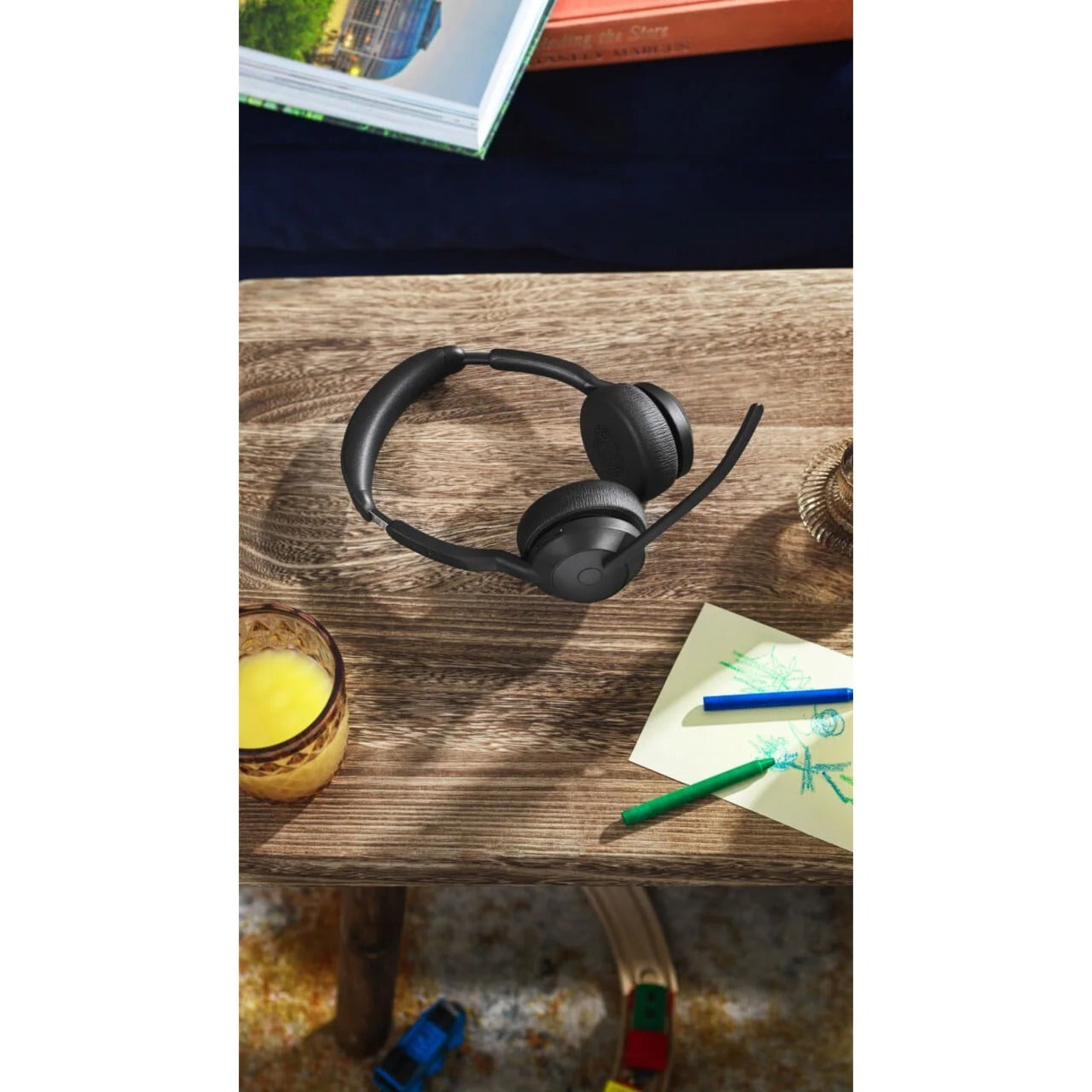 Jabra Evolve2 55 headset on wooden desk with personal items-alternate-image10