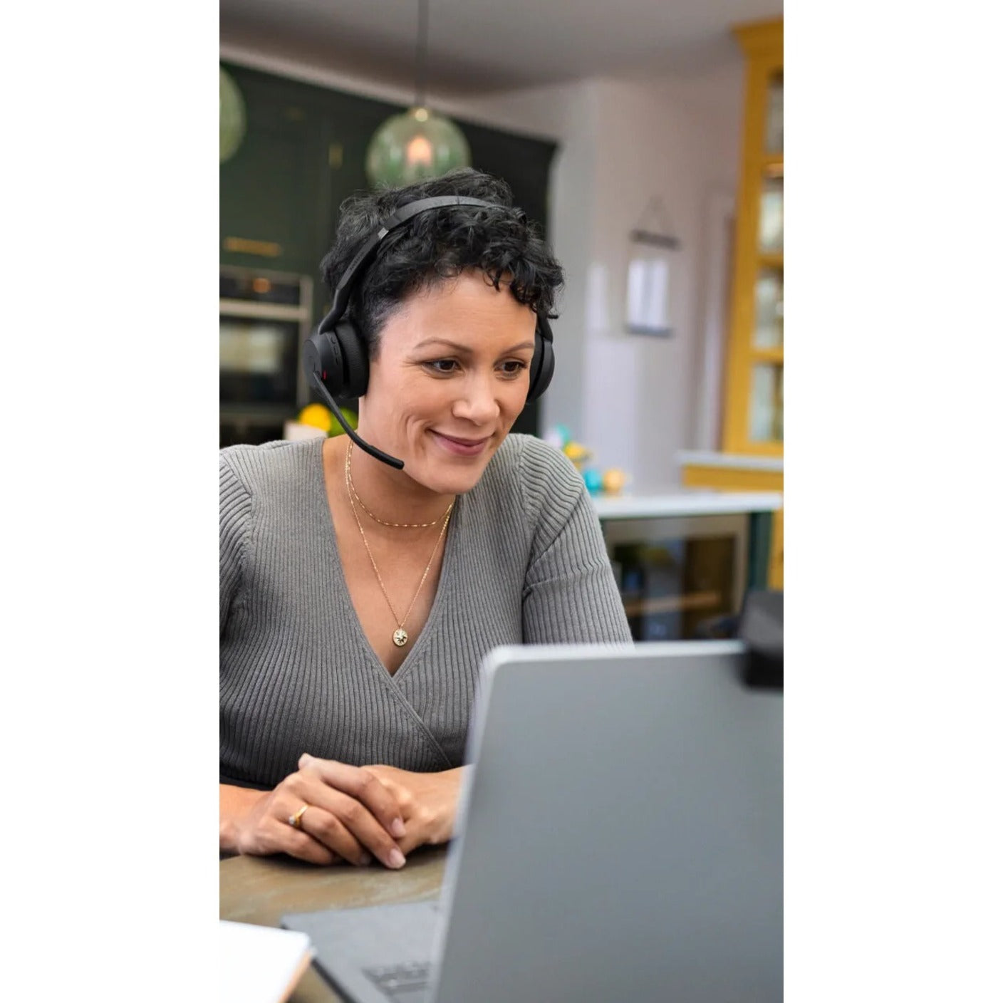 Person wearing Jabra Evolve2 55 headset while working on laptop-alternate-image7