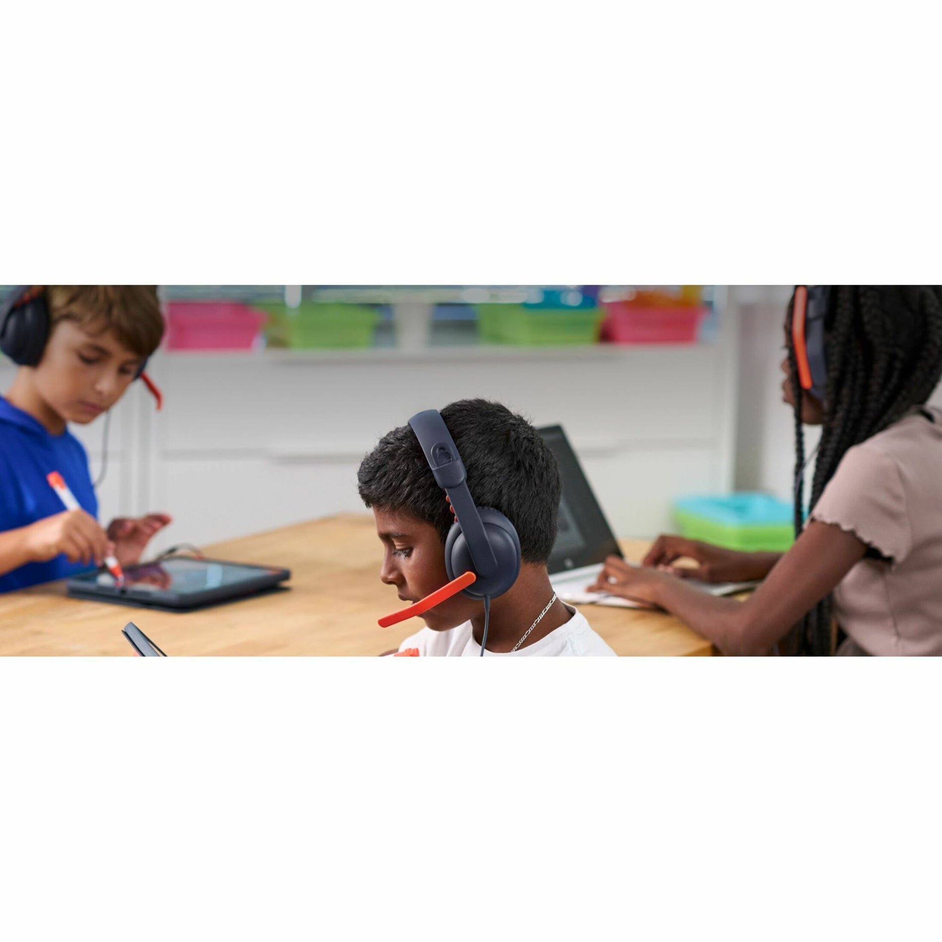 Students collaborating while wearing Logitech Zone Learn headsets in classroom setting-alternate-image6