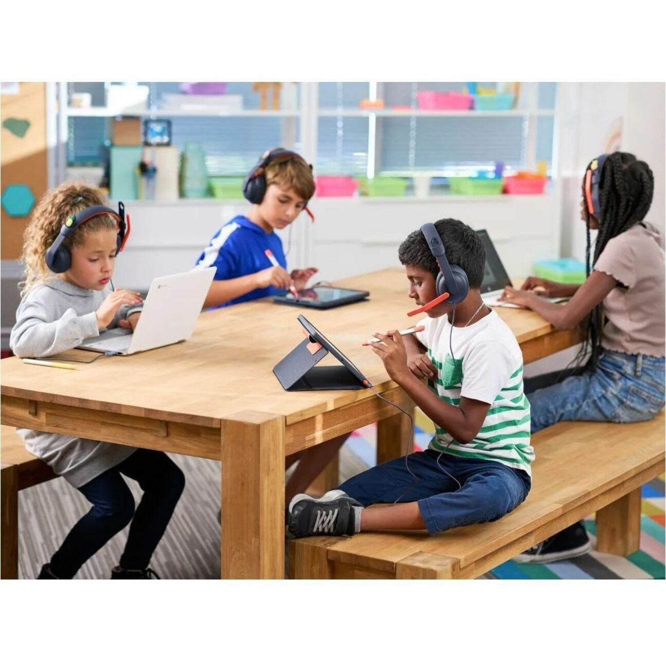 Multiple students using Logitech Zone Learn headsets in a collaborative learning space-alternate-image8