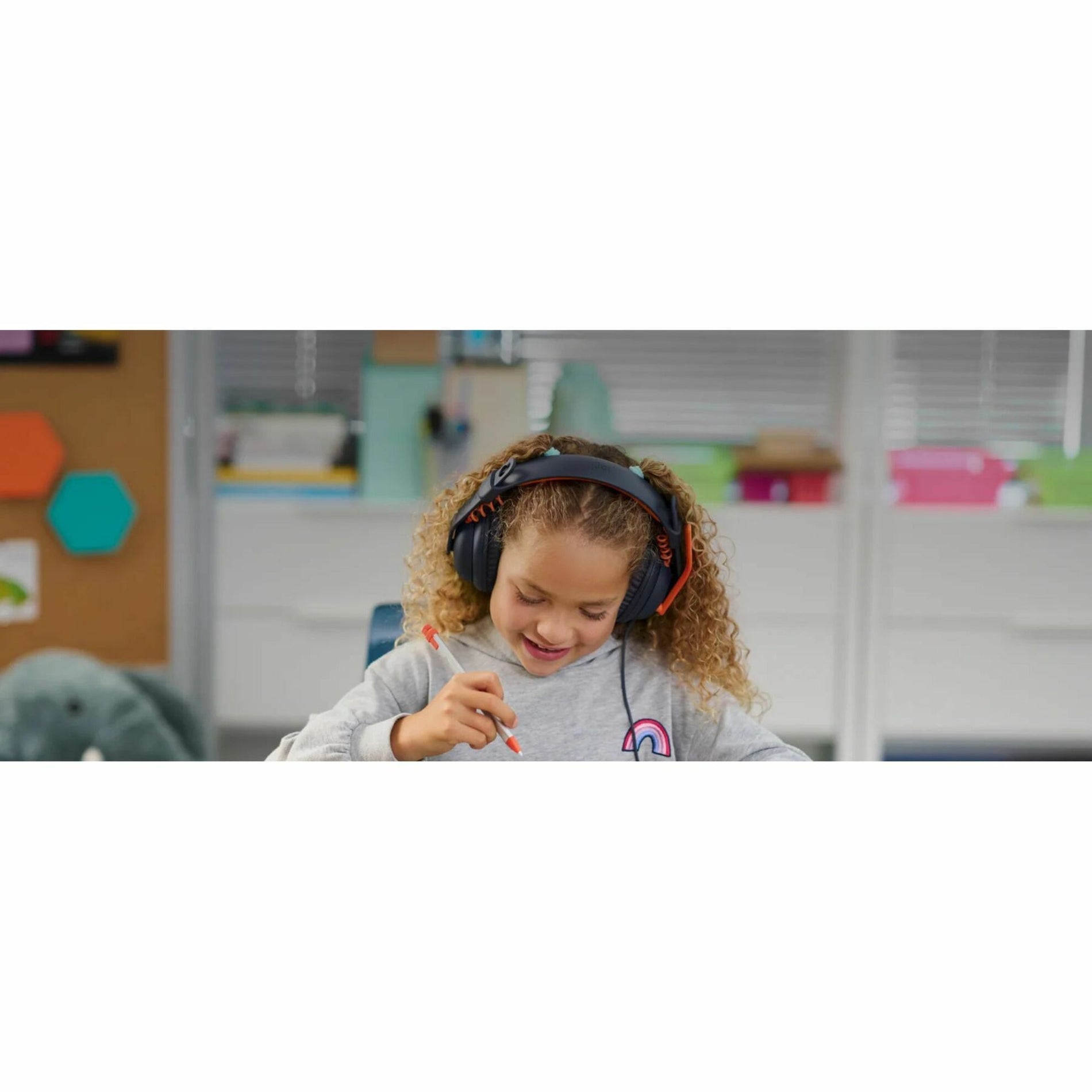 Student concentrating on schoolwork while wearing Logitech Zone Learn headset-alternate-image8