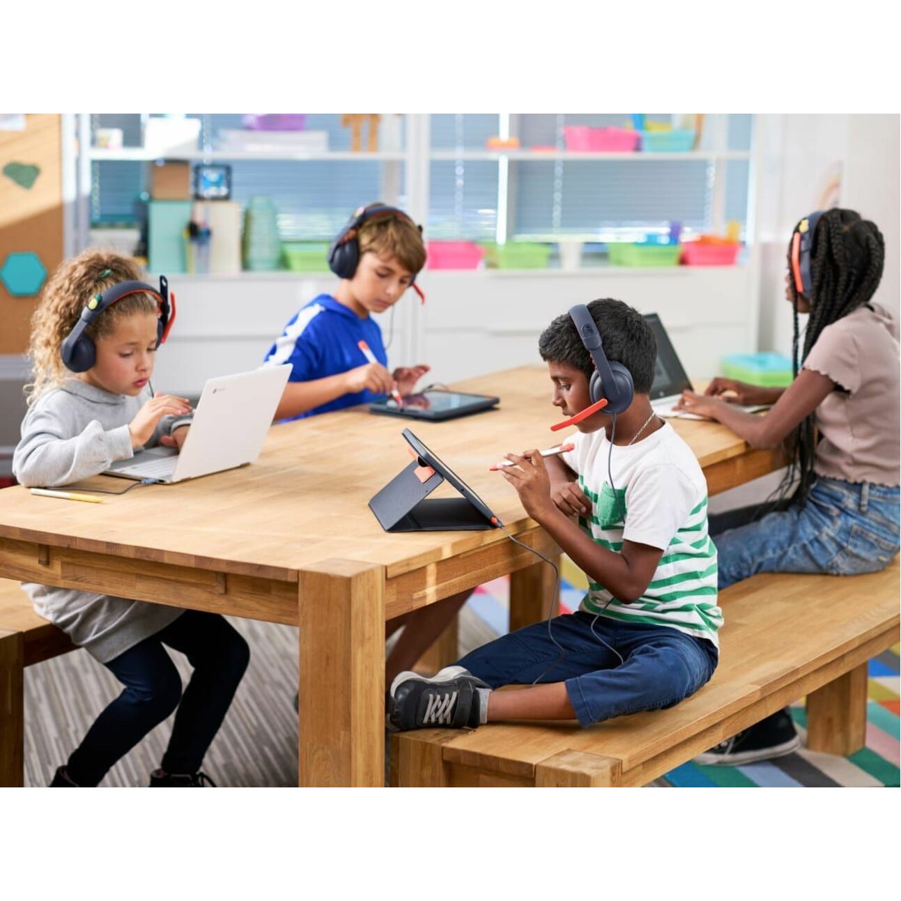 Students using Zone Learn headsets in a classroom setting with tablets and laptops-alternate-image4