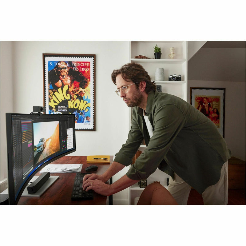 Creative professional working with curved HP E45c G5 monitor in home office setting