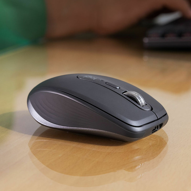 Side profile view of Logitech MX Anywhere 3S mouse on wooden surface