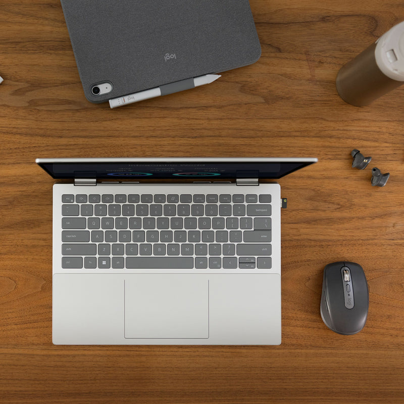 Overhead view of modern workspace with laptop, MX Anywhere 3S mouse, and accessories