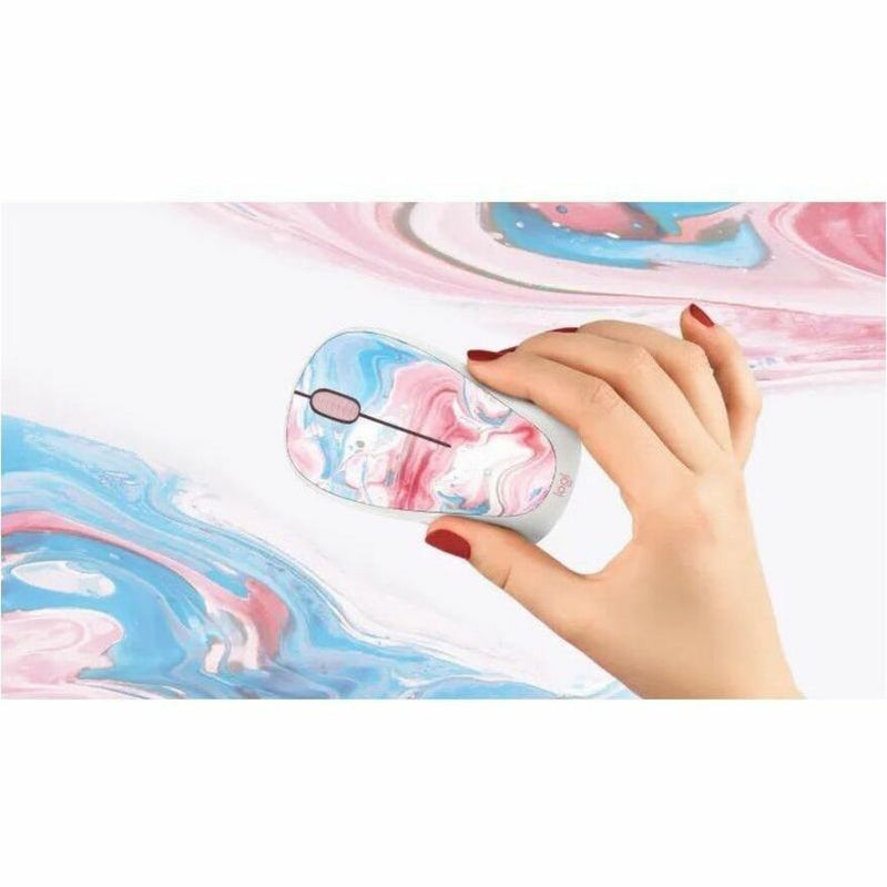 Lifestyle shot of hand using the cotton candy designed Logitech wireless mouse on a matching surface