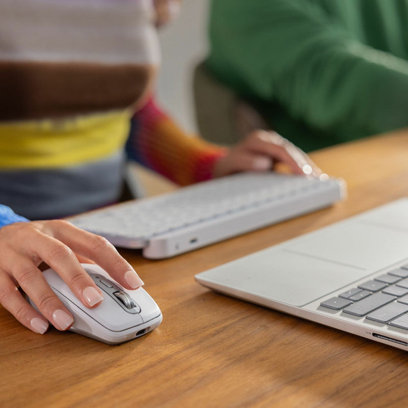 MX Anywhere 3S mouse being used with keyboard and laptop setup