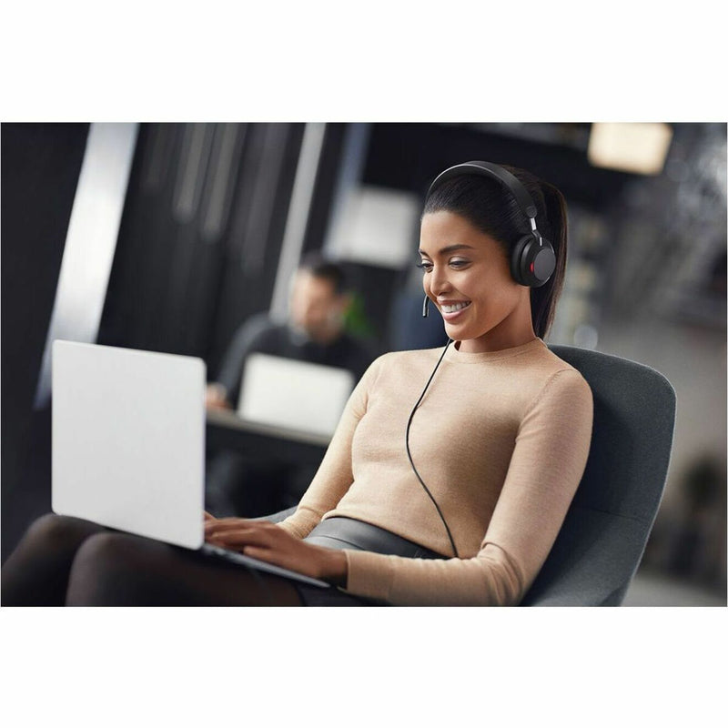 Professional engaged in laptop work while wearing Jabra Evolve2 40 SE headset