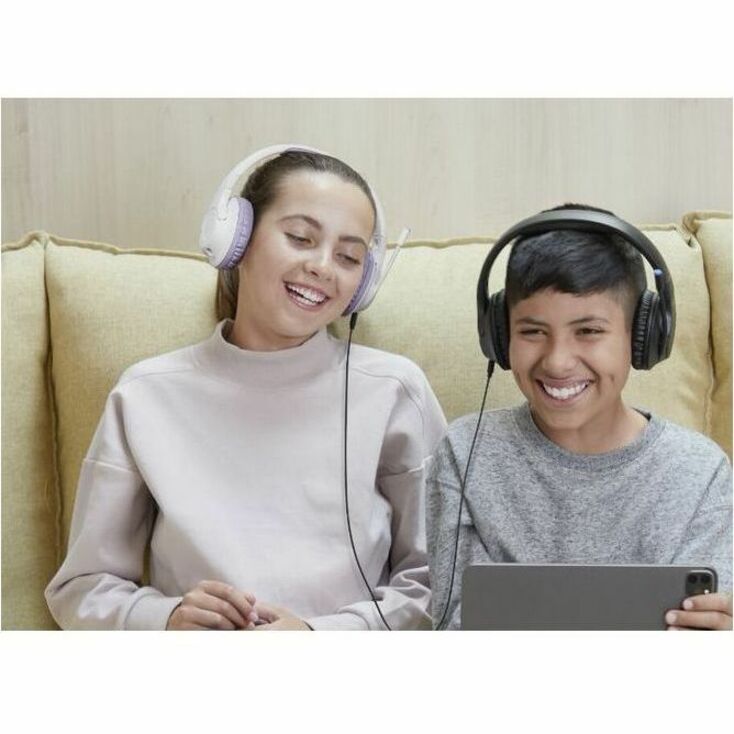 Two young people enjoying shared audio experience with Belkin SoundForm Inspire headphones