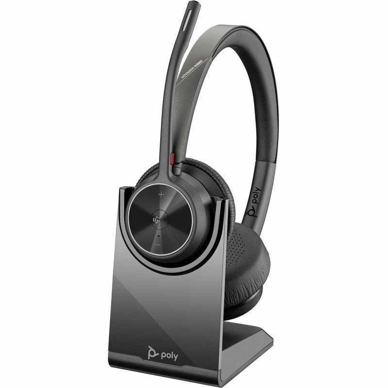 Poly Voyager 4320-M headset with charging stand in desktop setup