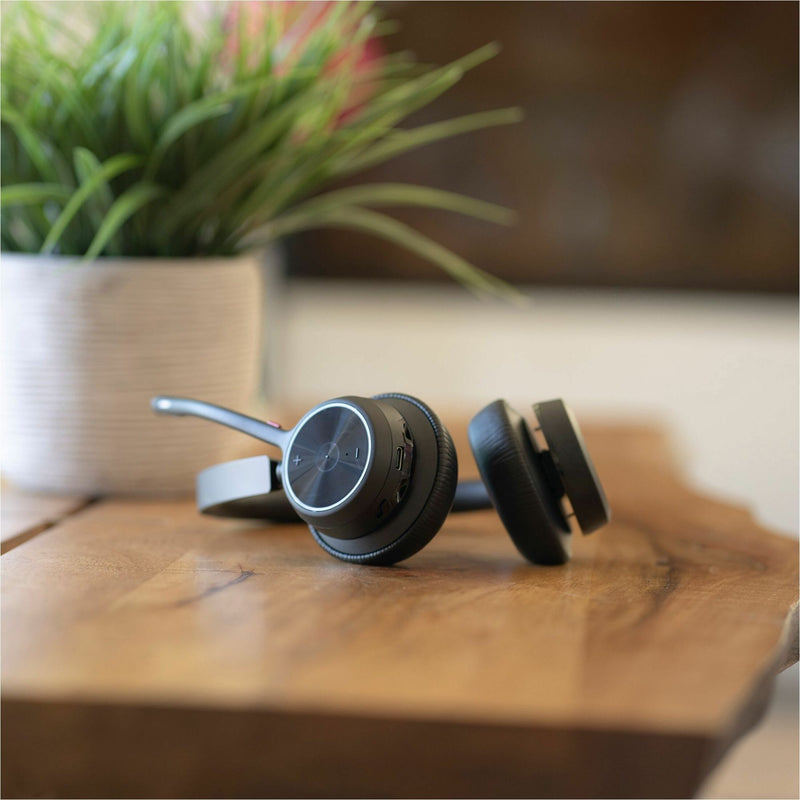 Poly Voyager 4320-M headset on wooden desktop