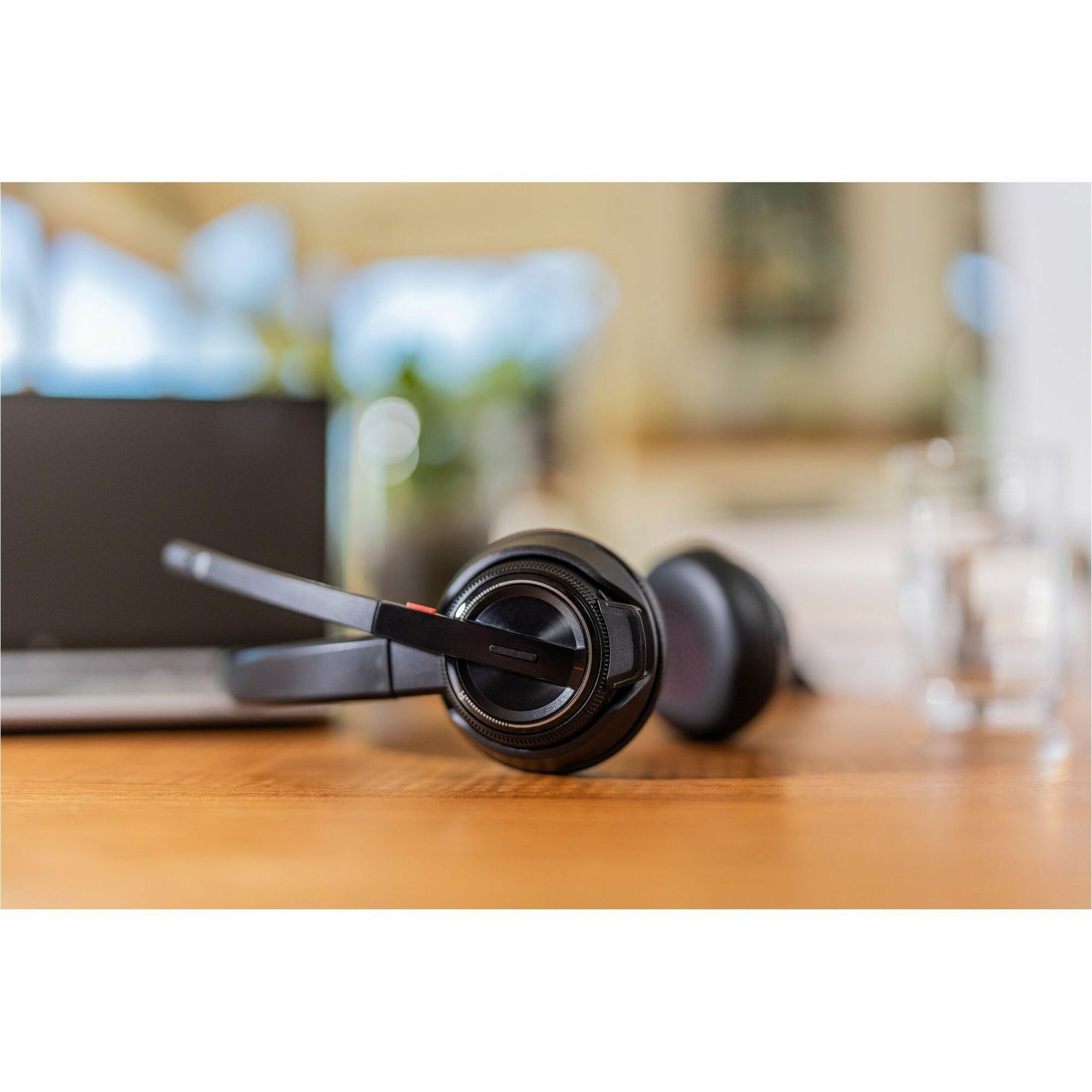 Poly Savi 8220 headset on wooden desk with laptop in background-alternate-image5