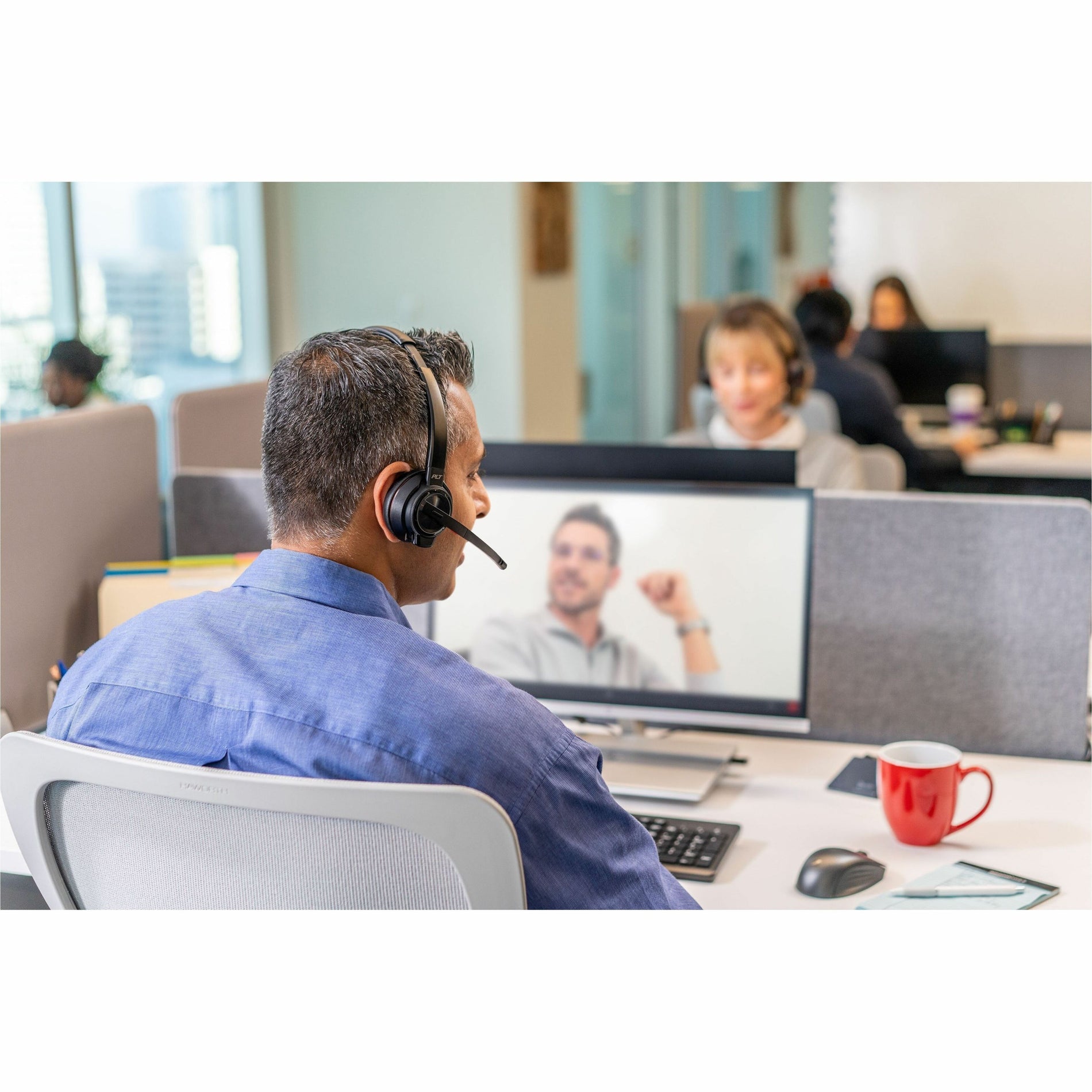 Office worker engaged in video call using Poly Savi 8210 headset in collaborative workspace-alternate-image6