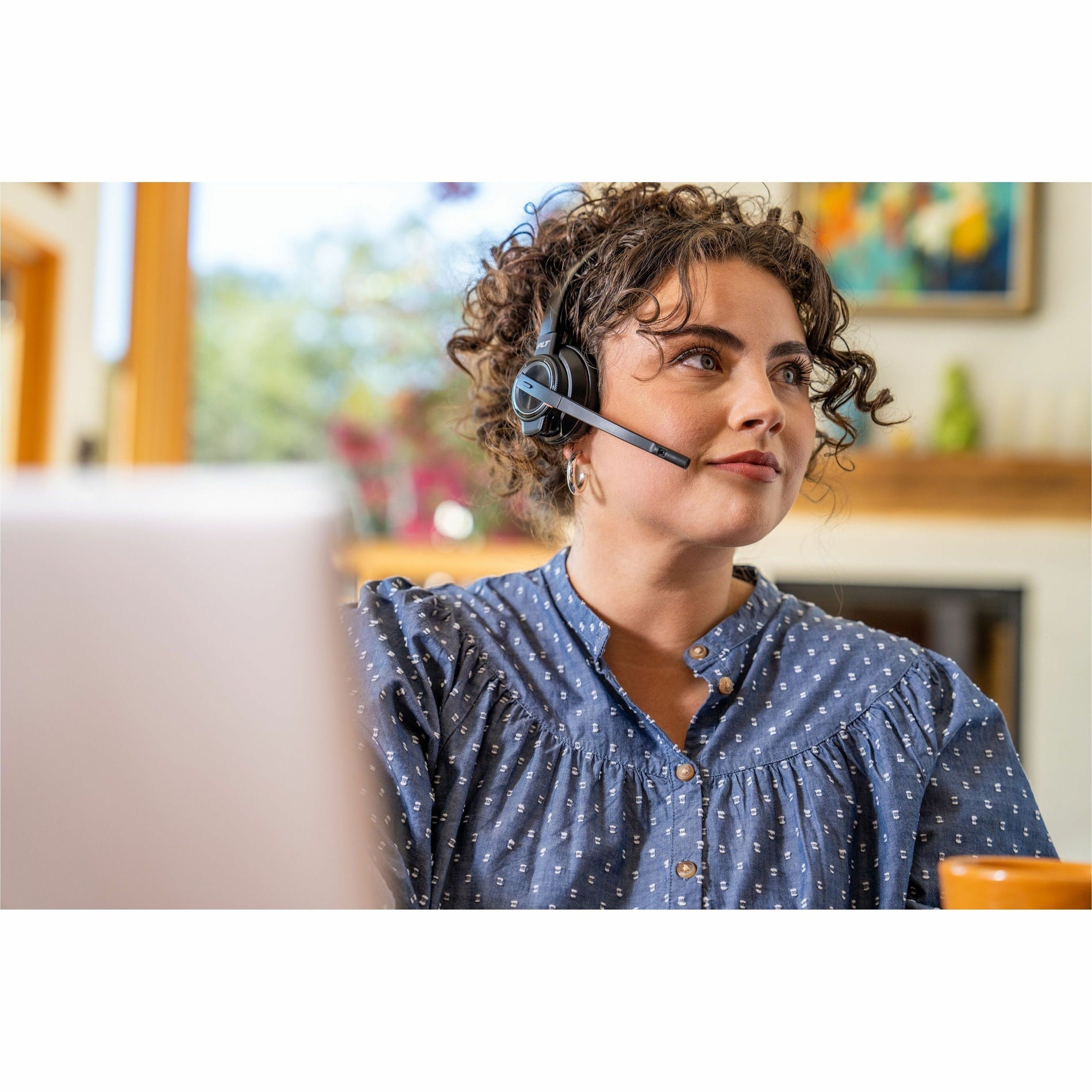 Person wearing Poly Savi 8210 headset while working from home office-alternate-image4