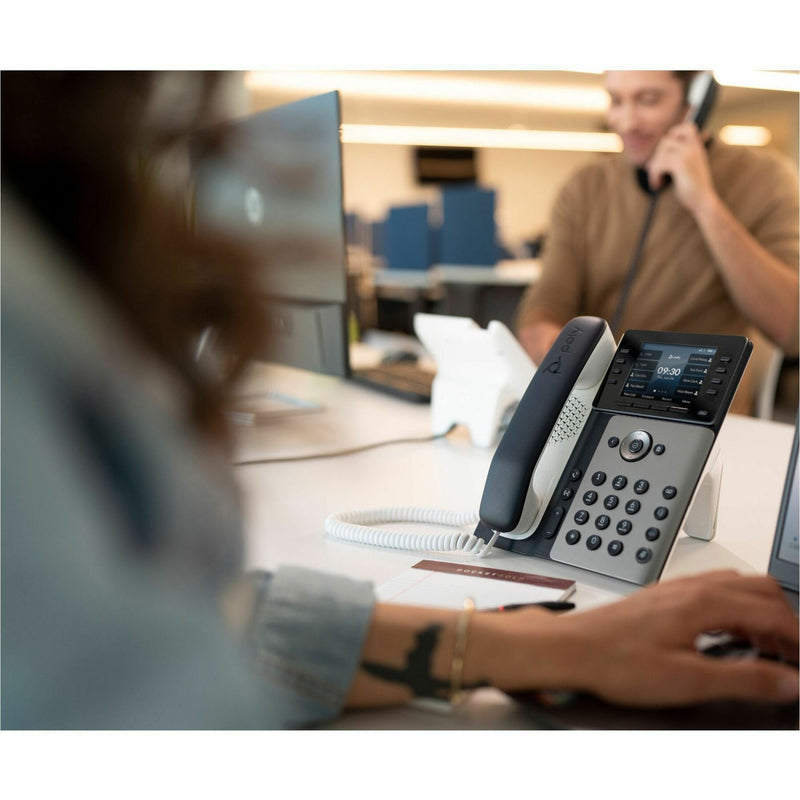 Poly Edge E350 phone in a modern office setting showing workspace integration