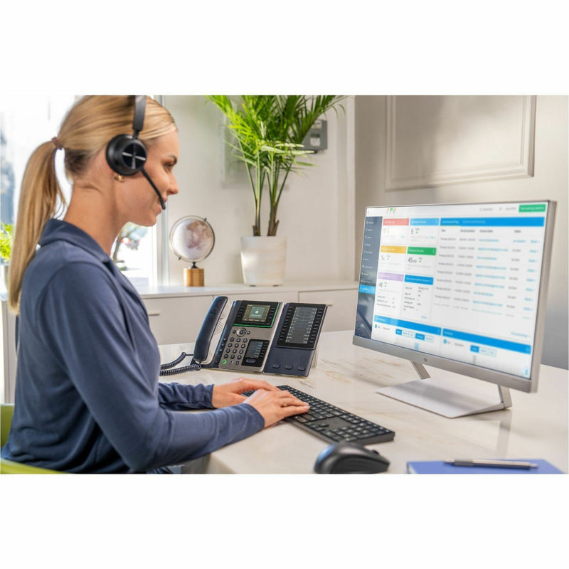 Professional using headset with Poly Edge E450