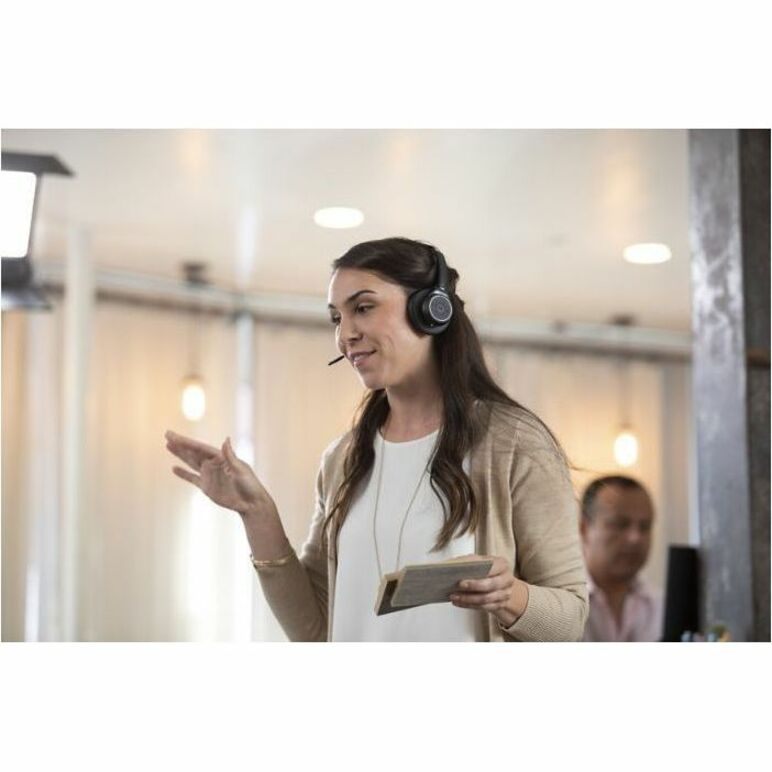 Professional using Poly Voyager 4320 headset while presenting in an office environment-alternate-image4