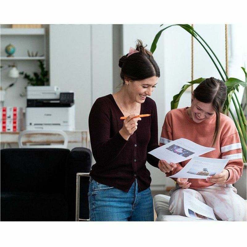 Office team reviewing documents printed using Canon printer with 070 toner cartridge