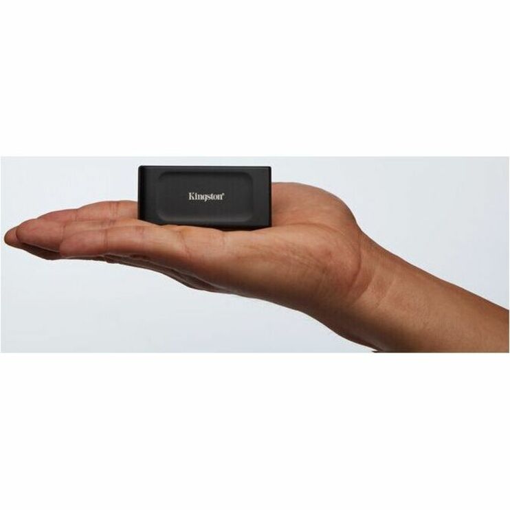 Kingston XS1000 External SSD held in palm showing size scale