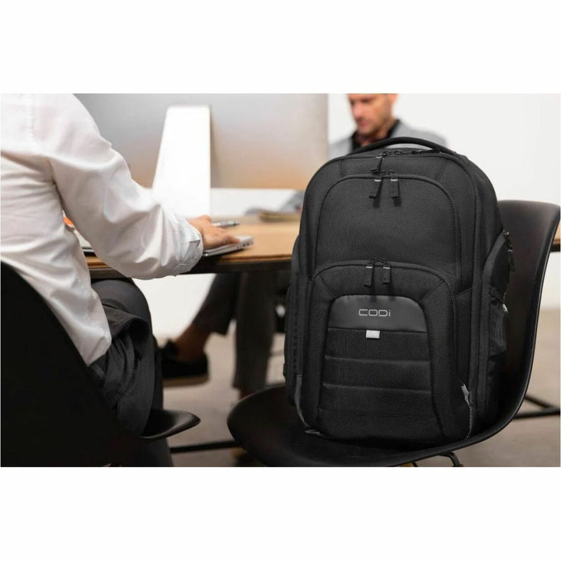 CODi backpack in office setting with professional at desk