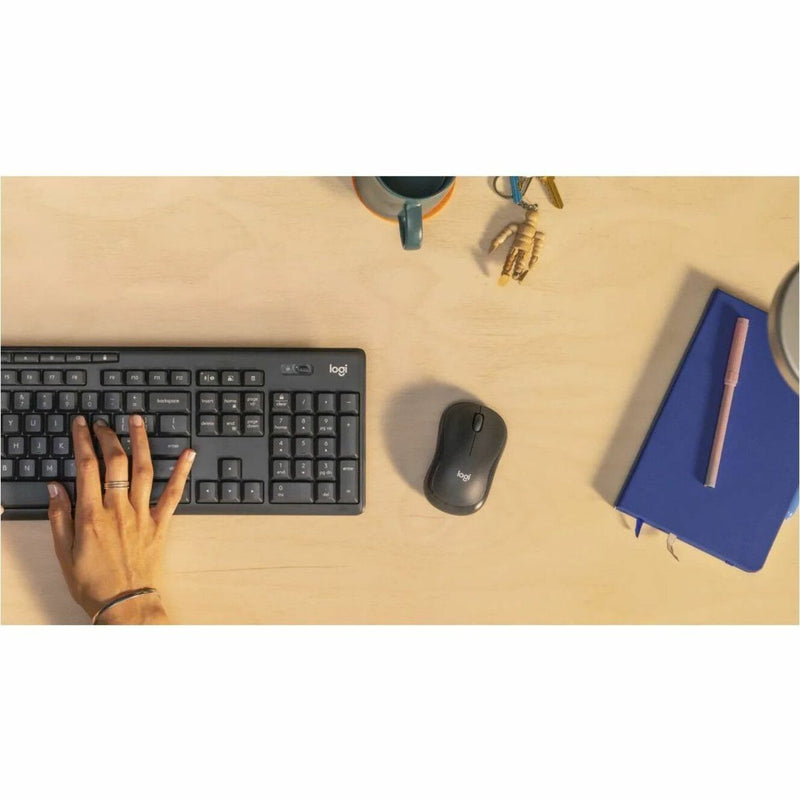 Workspace setup showing Logitech M240 mouse with keyboard and office accessories