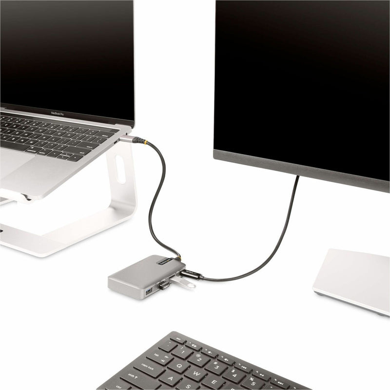 Close-up of laptop on stand connected to USB-C hub with external display