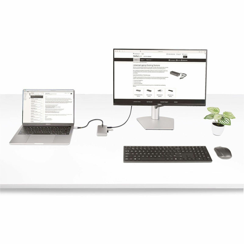 Complete desk setup showing laptop, monitor, keyboard, and mouse connected through the USB-C hub