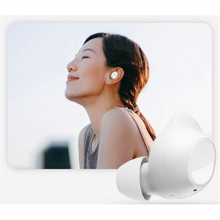 Person wearing white Galaxy Buds FE outdoors with serene expression, demonstrating noise cancellation feature