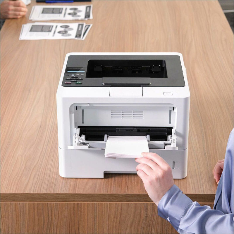 Person loading paper into Brother HL-L5210DW printer