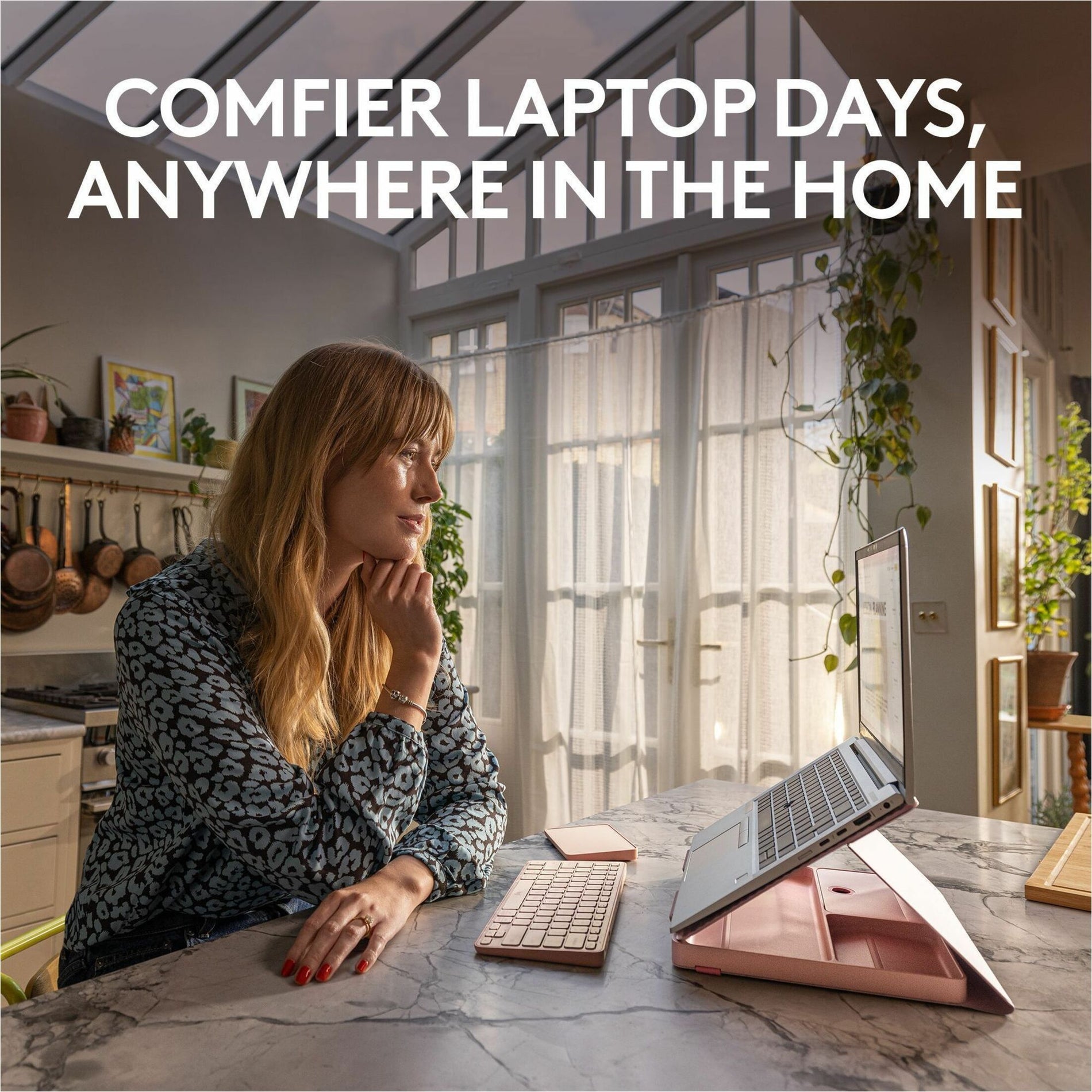 Person working comfortably at home with Logitech Casa Kit setup on marble countertop in sunlit room-alternate-image2