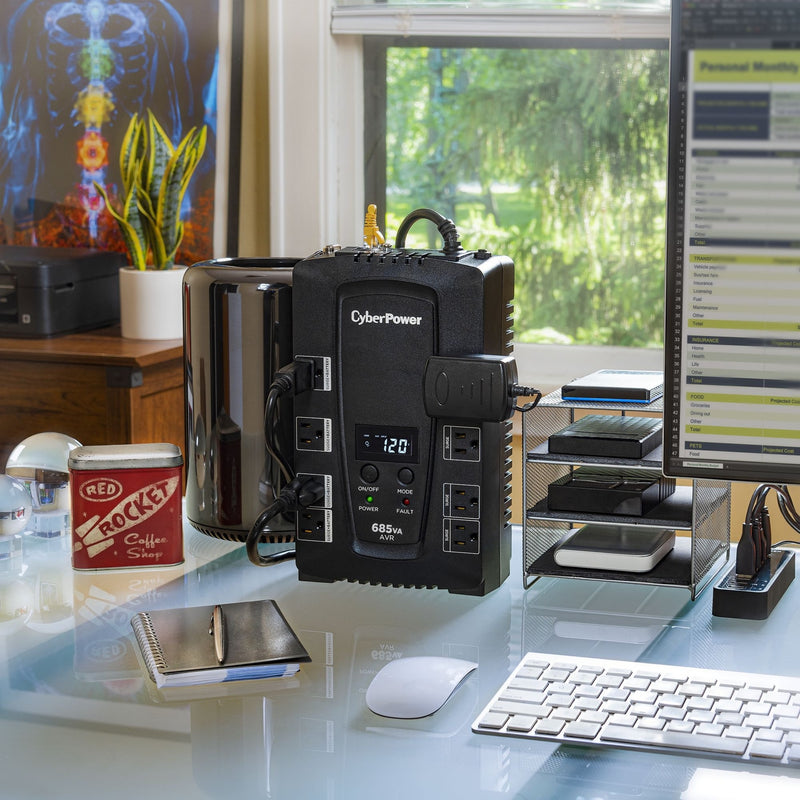 CyberPower CP685AVRLCD UPS in a home office setting protecting multiple devices