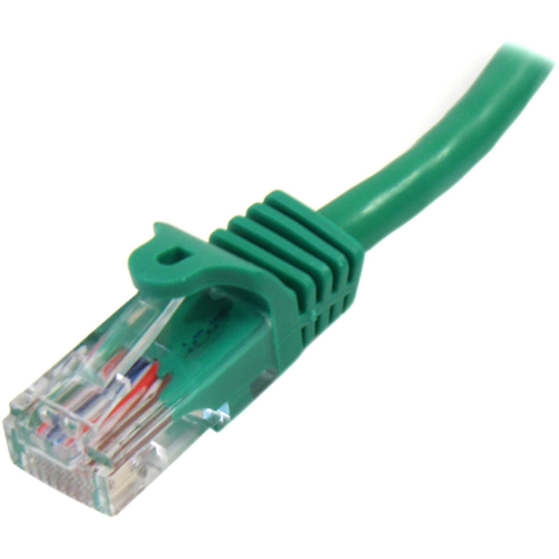 Detailed macro shot of green Cat5e ethernet cable connector showing strain relief and internal wiring