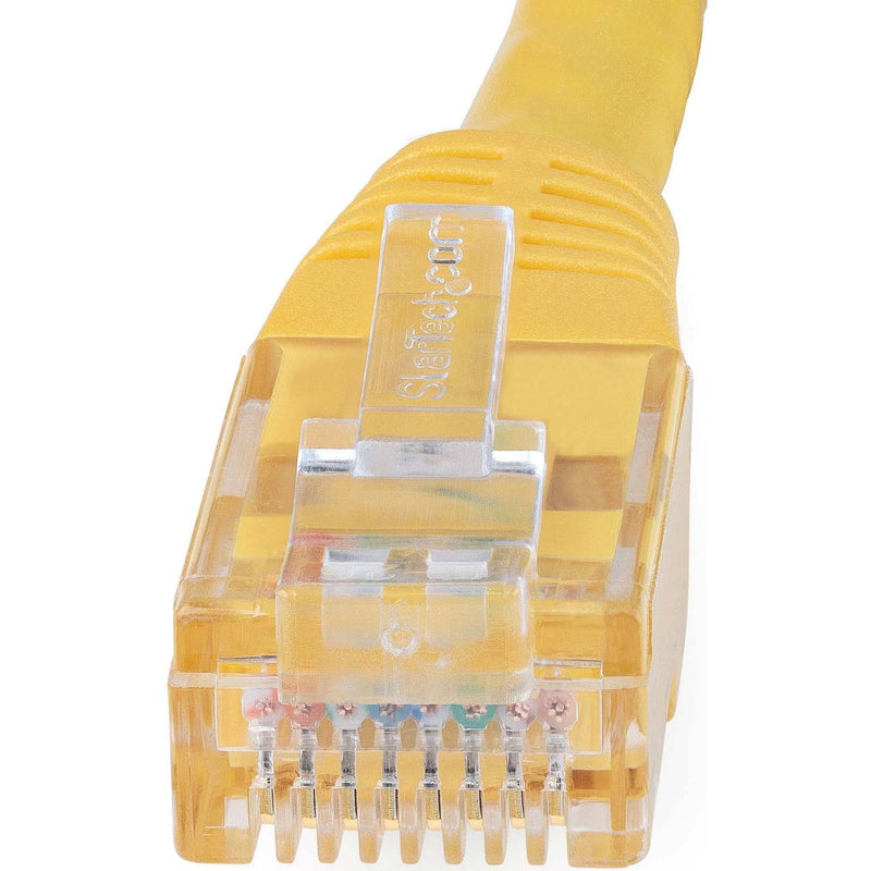 Macro shot of yellow Cat6 cable RJ45 connector showing internal wiring and contact pins